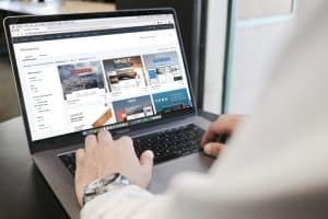 User browsing online marketplace on laptop for shopping reviews and ratings.